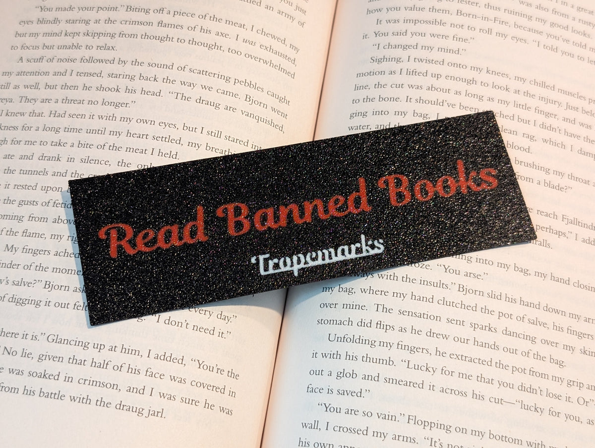 The words "Read Banned Books" in red lettering on a black rectangle bookmark